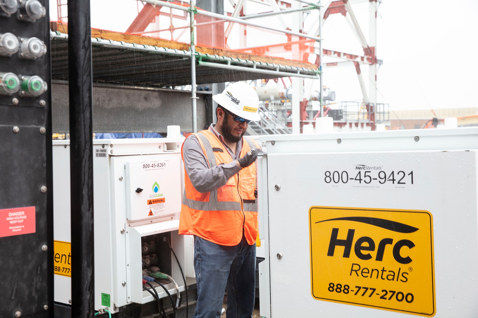 Worker working on Herc Rental Machine
