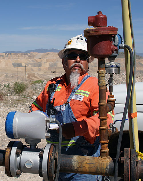 Rich Temoke, a Dewatering Ops Technician at Cortez, checks the pressure indicator for a dewatering well pump. He will visit each dewatering well site to inspect and record pumping rates, wellhead pressure and total gallons pumped during the preceding 24 hours. This data is compiled and reported monthly to local authorities.