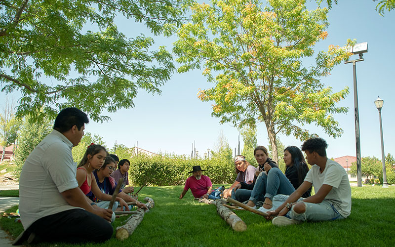 Students participate in traditional Shoshone hand games. “Our culture is connected to the language and sweat lodges,” says Anthony Maggio (pictured in bandana). “You can’t separate them.”