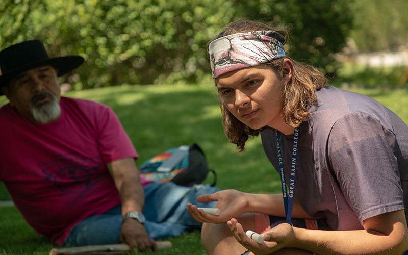 Students participate in traditional Shoshone hand games. “Our culture is connected to the language and sweat lodges,” says Anthony Maggio (pictured in bandana). “You can’t separate them.”