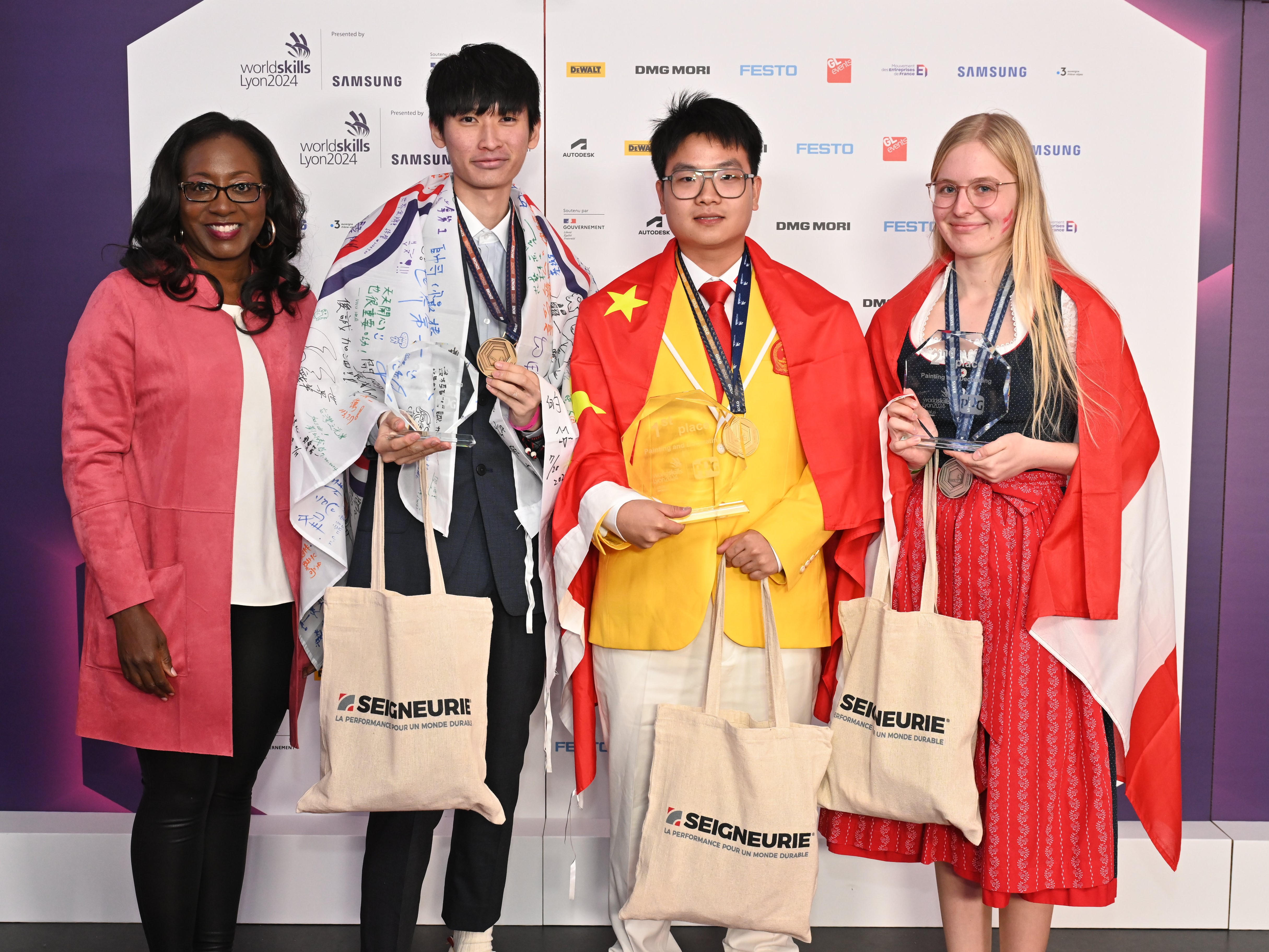 (Left to right): Malesia Dunn, executive director, PPG Foundation and corporate global social responsibility, with the winners of the Painting and Decorating category at WorldSkills Lyon 2024: Chun-Chen Lee, Xiaofei Zhang and Lena Prinz.
