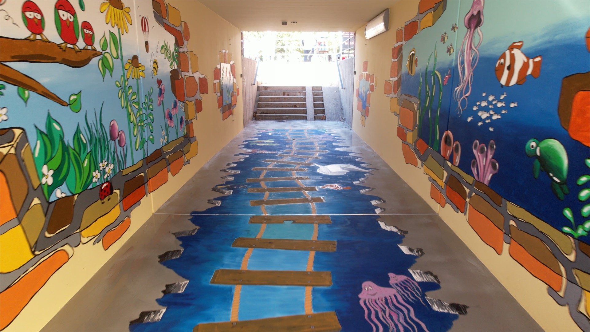 A COLORFUL COMMUNITIES® carried out by PPG volunteers at a middle school in Klingenberg am Main, Germany, included a mural for an underpass.